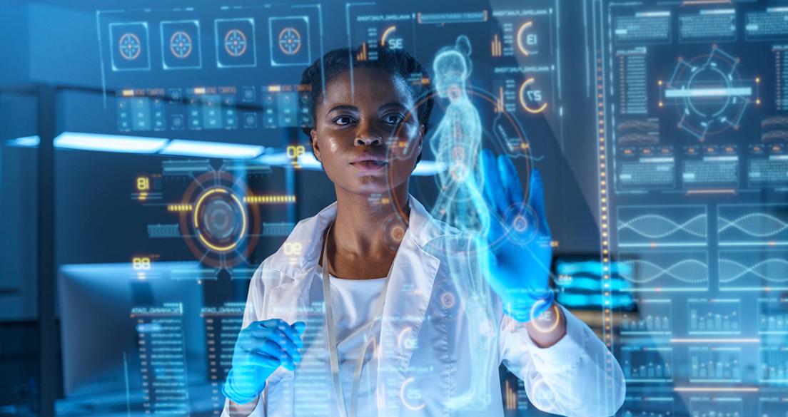 A young African-American doctor works on HUD or graphic display in front of her. We see her from the waist up in a modern laboratory.